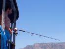 Fishing off the side of a sailing yacht